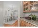 Dining room adjacent to granite countertop, cabinets and glass doors to hall at 5504 Spring Bluffs Ln, Raleigh, NC 27606