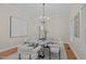 Stylish dining room with a marble table, comfortable chairs, and modern lighting at 5504 Spring Bluffs Ln, Raleigh, NC 27606
