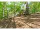 Wooded backyard with a charming house and a white wooden deck at 5504 Spring Bluffs Ln, Raleigh, NC 27606