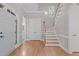Elegant foyer with a staircase, double doors, and a view of the powder room at 5504 Spring Bluffs Ln, Raleigh, NC 27606