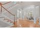 Open foyer with a staircase, arched doorways, hardwood floors, and elegant decor at 5504 Spring Bluffs Ln, Raleigh, NC 27606