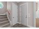 Hallway with carpeted stairs and view of kitchen at 5504 Spring Bluffs Ln, Raleigh, NC 27606