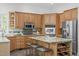 Spacious kitchen featuring stainless steel appliances, tile backsplash, an island, and barstool seating at 5504 Spring Bluffs Ln, Raleigh, NC 27606