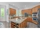 Spacious kitchen featuring stainless steel appliances, tile backsplash, an island, and barstool seating at 5504 Spring Bluffs Ln, Raleigh, NC 27606