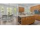 Open kitchen featuring granite countertops, stainless appliances, wine rack, and eat-in breakfast nook at 5504 Spring Bluffs Ln, Raleigh, NC 27606