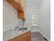 Laundry room with a granite countertop, sink, cabinets, and a window at 5504 Spring Bluffs Ln, Raleigh, NC 27606