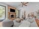 Bright living room with a stone fireplace, modern furniture, and sliding glass doors at 5504 Spring Bluffs Ln, Raleigh, NC 27606
