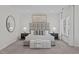Main bedroom featuring a large, tufted headboard and a seating area at 5504 Spring Bluffs Ln, Raleigh, NC 27606
