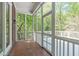 Screened porch with brick accents and views of surrounding trees and foliage at 5504 Spring Bluffs Ln, Raleigh, NC 27606