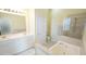 Bright bathroom with a soaking tub, walk-in shower, and double vanity sinks at 5901 Chivalry Ct, Raleigh, NC 27612