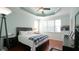 A bright bedroom with hardwood floors, lots of natural light, and a ceiling fan at 5901 Chivalry Ct, Raleigh, NC 27612
