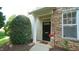 Charming front entrance featuring a black door, stone facade, and manicured landscaping at 5901 Chivalry Ct, Raleigh, NC 27612