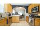 Bright kitchen with granite countertops, stainless steel appliances, and wood cabinets at 5901 Chivalry Ct, Raleigh, NC 27612