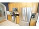 Updated kitchen featuring stainless steel appliances and light wood cabinets at 5901 Chivalry Ct, Raleigh, NC 27612