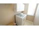 Laundry room with white cabinets and a large washing machine at 5901 Chivalry Ct, Raleigh, NC 27612