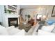 Spacious living room with hardwood floors, fireplace, and view into dining area at 5901 Chivalry Ct, Raleigh, NC 27612
