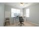 Bright office with multiple monitors, chair and a ceiling fan at 5901 Chivalry Ct, Raleigh, NC 27612