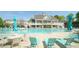 A swimming pool in front of a multi-story house with lounge chairs around it at 5901 Chivalry Ct, Raleigh, NC 27612