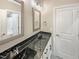 Elegant bathroom with double sinks, black marble countertop, and modern fixtures at 6245 Reagan Ln, Wake Forest, NC 27587