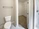 Modern bathroom with marble floors, a toilet, and an open door to a closet and shower at 6245 Reagan Ln, Wake Forest, NC 27587