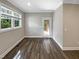 Light-filled bedroom with vinyl floors and a view of the outdoor deck through a glass door at 6245 Reagan Ln, Wake Forest, NC 27587
