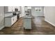 Open kitchen showcasing stainless steel appliances, granite countertops, and an island at 6245 Reagan Ln, Wake Forest, NC 27587
