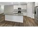Bright kitchen featuring stainless steel appliances, granite countertops, and a kitchen island at 6245 Reagan Ln, Wake Forest, NC 27587