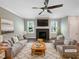 Bright living room featuring a cozy fireplace, modern ceiling fan, and stylish neutral decor at 6245 Reagan Ln, Wake Forest, NC 27587