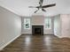 Bright living room with a dark stone fireplace and hardwood floors, perfect for relaxation and entertaining at 6245 Reagan Ln, Wake Forest, NC 27587