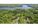 Lush aerial view highlighting a home near a peaceful lake and dense trees at 6614 Chantilley Place, Bahama, NC 27503
