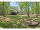 Lush backyard featuring a well-maintained lawn, mature trees, and an inviting outdoor space at 6614 Chantilley Place, Bahama, NC 27503