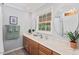 Bright bathroom features ample counter space, a large mirror, and a window bringing in natural light at 6614 Chantilley Place, Bahama, NC 27503
