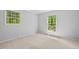 Bright, empty bedroom with carpet, two windows, and natural light, perfect for customization at 6614 Chantilley Place, Bahama, NC 27503