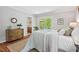 Comfortable bedroom with stylish decor, private deck access, and warm natural light. Ensuite bathroom is visible at 6614 Chantilley Place, Bahama, NC 27503