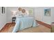 Inviting bedroom featuring neutral tones, twin bedside lamps, ample natural light, and closet for storage at 6614 Chantilley Place, Bahama, NC 27503