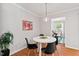 Bright dining area with modern lighting and seating for four at 6614 Chantilley Place, Bahama, NC 27503