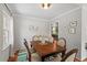 Charming dining room with a wood table, neutral walls, and natural light from the window at 6614 Chantilley Place, Bahama, NC 27503