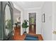 Bright foyer with hardwood floors and an elegant oval glass window on the front door at 6614 Chantilley Place, Bahama, NC 27503