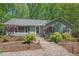 Charming single story home featuring manicured landscaping and a brick pathway to the front door at 6614 Chantilley Place, Bahama, NC 27503