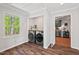 Bright laundry area features modern washer and dryer, wood countertop, and window providing ample natural light at 6614 Chantilley Place, Bahama, NC 27503
