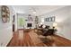 Inviting living room features hardwood floors, fireplace, and access to the outdoors at 6614 Chantilley Place, Bahama, NC 27503
