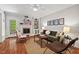 Comfortable living room with a fireplace, built-in shelving, and hardwood floors at 6614 Chantilley Place, Bahama, NC 27503