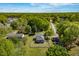Aerial view of property showcasing the house, expansive green landscape, and surrounding mature trees at 7308 York, Mebane, NC 27302