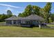 Spacious backyard featuring a well-maintained lawn and a charming enclosed sunroom attached to the home at 7308 York, Mebane, NC 27302
