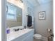 Neutral toned bathroom with a white single vanity and decor at 7308 York, Mebane, NC 27302