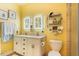 Bright bathroom featuring double vanity, tiled shower, and yellow walls at 7308 York, Mebane, NC 27302