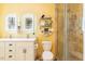Bright bathroom with double vanity, backlit mirrors, toilet, and a fully tiled shower with glass door at 7308 York, Mebane, NC 27302