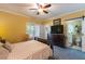 Cozy bedroom featuring carpeted floors, a ceiling fan, and a doorway to the ensuite bathroom at 7308 York, Mebane, NC 27302