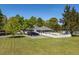 Side view of property showcasing the house, driveway, large lot, and classic white picket fence at 7308 York, Mebane, NC 27302