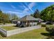 View of house with well maintained lawn and charming white picket fence, complemented by blooming flower bushes at 7308 York, Mebane, NC 27302